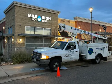 Smart Signs Denver bucket truck outside Mile High Hot Tubs